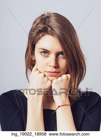portrait of beautiful young brunette girl holding hand on chin isolated on gray background View Large Photo Image Stock Photo - portrait of beautiful young brunette girl holding hand on chin isolated on gray background. Fotosearch
