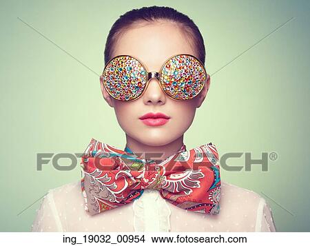 Picture - Portrait of beautiful young woman with colored glasses. Beauty fashion. Perfect make-up. Colorful decoration. Jewelry. Fotosearch