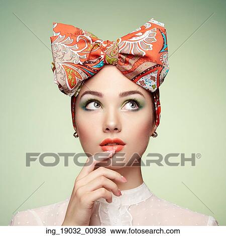 Stock Photo - Portrait of beautiful young woman with bow. Brunette girl. Beauty fashion. Cosmetic make-up. Fotosearch
