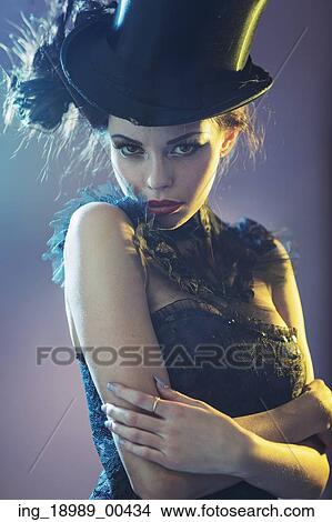 Picture - Portrait of the alluring young female model with the black top hat. Fotosearch