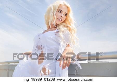 Stock Photo - Portrait of the blonde wearing ragged white dress. Fotosearch
