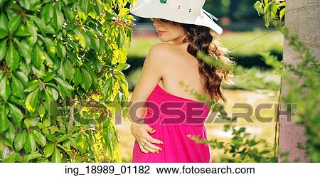 Stock Image - Portrait of the calm woman wearing colorful summer clothes. Fotosearch