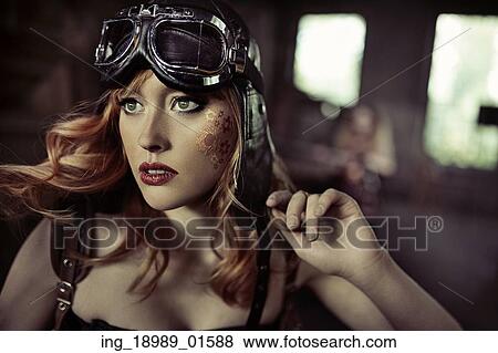 Stock Photo - Portrait of the fabulous redhead airwoman. Fotosearch