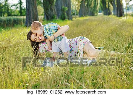 Portrait of the happy family in the fresh park View Large Photo Image Stock Image - Portrait of the happy family in the fresh park. Fotosearch