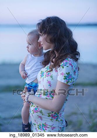 Portrait of the happy mom holding her baby View Large Photo Image Stock Photography - Portrait of the happy mom holding her baby. Fotosearch