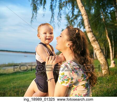 Stock Photography - Portrait of the laughing mother and kid. Fotosearch