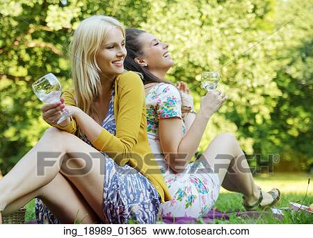Stock Photography - Portrait of the two young, cheerful girlfriends. Fotosearch