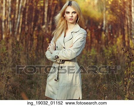 Portrait of young beautiful woman in autumn cloak. Fashion photo. Blonde girl. Perfect make-up View Large Photo Image Stock Image - Portrait of young beautiful woman in autumn cloak. Fashion photo. Blonde girl. Perfect make-up. Fotosearch