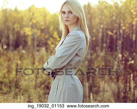 Portrait of young beautiful woman in autumn cloak. Fashion photo. Blonde girl. Perfect make-up View Large Photo Image Stock Image - Portrait of young beautiful woman in autumn cloak. Fashion photo. Blonde girl. Perfect make-up. Fotosearch
