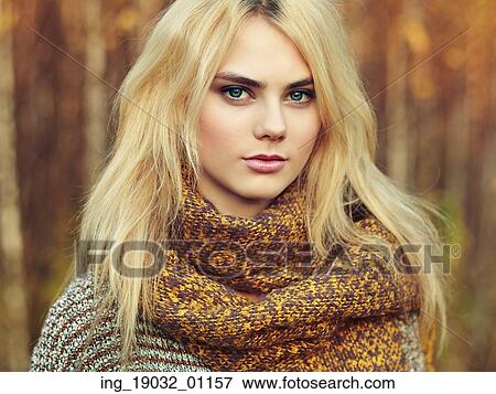 Portrait of young beautiful woman in autumn pullover. Fashion photo. Blonde girl. Perfect make-up View Large Photo Image Stock Photo - Portrait of young beautiful woman in autumn pullover. Fashion photo. Blonde girl. Perfect make-up. Fotosearch