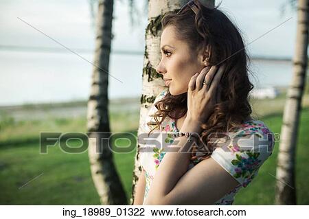 Stock Image - Portriat of the charming brunette looking at the sea. Fotosearch