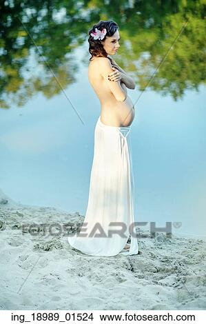 Pregnant lady touching her belly View Large Photo Image Picture - Pregnant lady touching her belly. Fotosearch