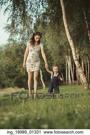 Pregnant mom walking with little child View Large Photo Image Stock Image - Pregnant mom walking with little child. Fotosearch