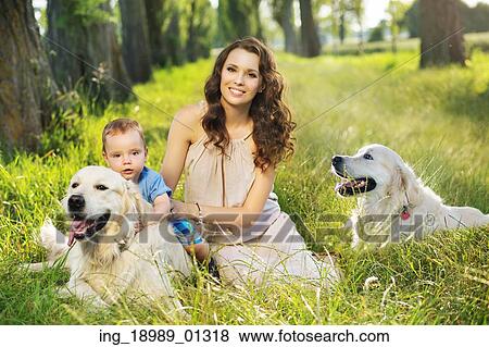 Stock Photo - Pretty mother with little child and dogs. Fotosearch