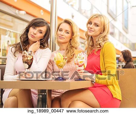 Stock Photo - Pretty women at the middle-day meeting. Fotosearch