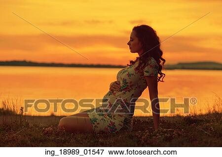 Realxed lady looking at the sunset View Large Photo Image Stock Photo - Realxed lady looking at the sunset. Fotosearch