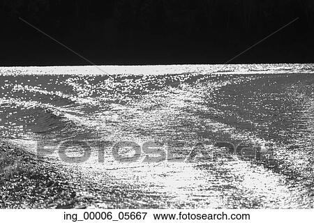 Stock Photo - Reflection of light off a lake, Lake Of The Woods, Ontario, Canada. Fotosearch