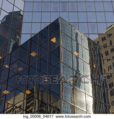 Stock Photo - Reflection of skyscrapers on the glass of another building, Golden Square Mile, Montreal, Quebec, Canada. Fotosearch