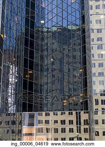 Stock Photo - Reflection of skyscrapers on the glass of another building, Golden Square Mile, Montreal, Quebec, Canada. Fotosearch
