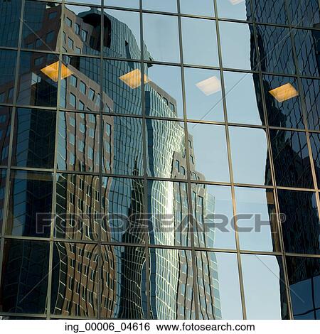 Stock Photograph - Reflection of skyscrapers on the glass of another building, Golden Square Mile, Montreal, Quebec, Canada. Fotosearch