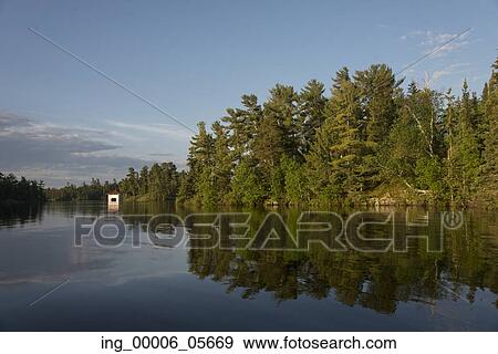 Reflection of trees on water, Lake Of The Woods, Ontario, Canada View Large Photo Image Stock Photo - Reflection of trees on water, Lake Of The Woods, Ontario, Canada. Fotosearch