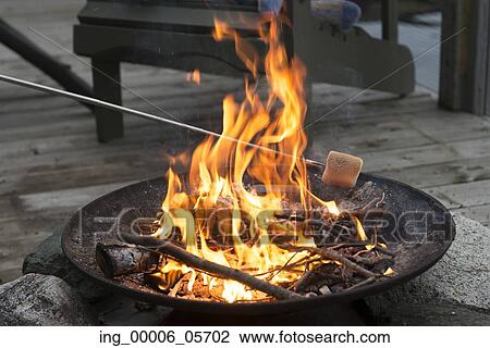 Roasting a Marshmallow over a Campfire, Lake Of The Woods, Ontario, Canada View Large Photo Image Stock Image - Roasting a Marshmallow over a Campfire, Lake Of The Woods, Ontario, Canada. Fotosearch