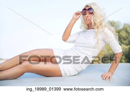 Sensual businesswoman relaxing by the lakeside View Large Photo Image Stock Photo - Sensual businesswoman relaxing by the lakeside. Fotosearch