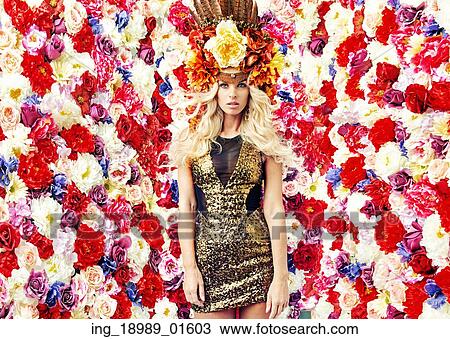 Stock Image - Sensual woman over the flower wall background. Fotosearch