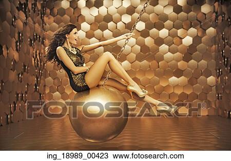 Sensual woman playing on the big gold ball View Large Photo Image Stock Image - Sensual woman playing on the big gold ball. Fotosearch
