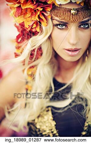 Stock Photo - Serious lady wearing colorful wreath. Fotosearch