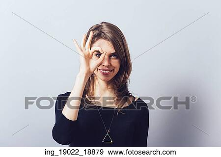 Stock Photo - shows glasses out of fingers, against background. Fotosearch