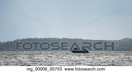 Silhouette of people on boat in a lake, Lake of the Woods, Ontario, Canada View Large Photo Image Stock Image - Silhouette of people on boat in a lake, Lake of the Woods, Ontario, Canada. Fotosearch