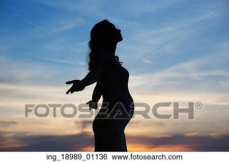 Silhouette of the cheerful pregnant woman View Large Photo Image Stock Photograph - Silhouette of the cheerful pregnant woman. Fotosearch