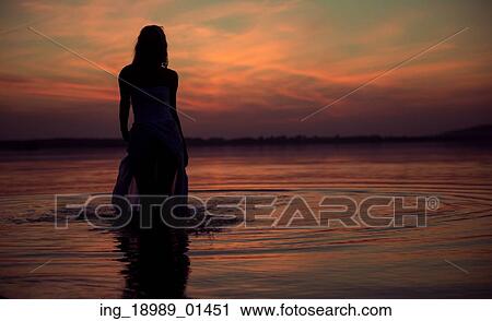 Silhouette of the young water nymph View Large Photo Image Stock Image - Silhouette of the young water nymph. Fotosearch