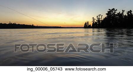 Silhouette of trees at the lakeside, Lake Of The Woods, Ontario, Canada View Large Photo Image Stock Image - Silhouette of trees at the lakeside, Lake Of The Woods, Ontario, Canada. Fotosearch