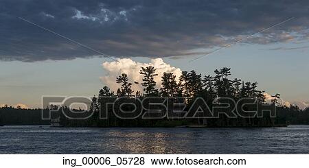 Stock Photo - Silhouette of trees at the lakeside, Lake Of The Woods, Ontario, Canada. Fotosearch