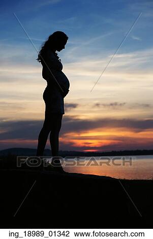 Silhouette of woman touching her belly View Large Photo Image Stock Image - Silhouette of woman touching her belly. Fotosearch