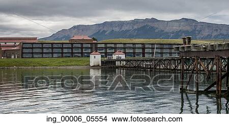 Picture - Singular Hotel with mountain range in the background, Puerto Natales, Patagonia, Chile. Fotosearch