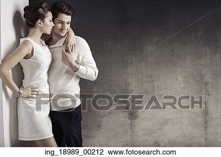 Stock Image - Slim woman with her muscular boyfriend. Fotosearch