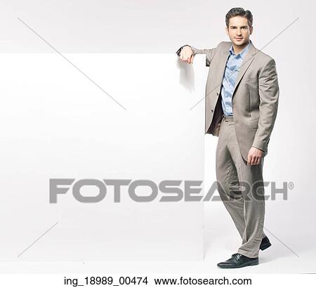 Smart fit man with large white board View Large Photo Image Picture - Smart fit man with large white board. Fotosearch