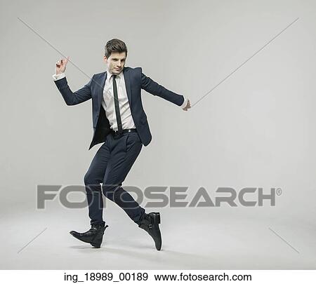 Stock Photo - Smart young man in victorious gesture. Fotosearch