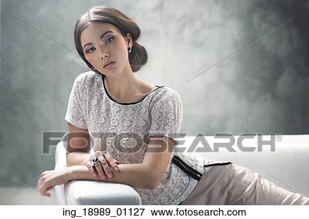 Stock Photo - Smart young woman with excellent classic hairstyle. Fotosearch