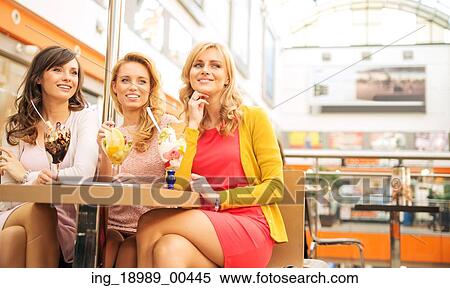 Smiling girlfriends enjoying their sweet dessert View Large Photo Image Stock Photography - Smiling girlfriends enjoying their sweet dessert. Fotosearch