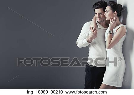 Stock Image - Smiling young lovers in just casual pose. Fotosearch
