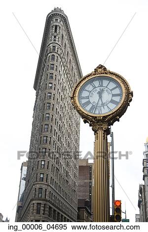 Stock Photography - Street clock in front of the Flatiron Building, Manhattan, New York City, New York State, USA. Fotosearch