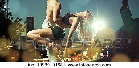 Stock Image - Strong man holding his alluring girlfriend. Fotosearch
