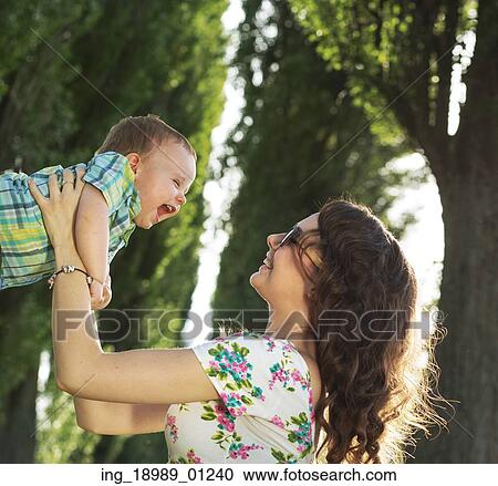 Stock Image - Tender mother playing with her son. Fotosearch