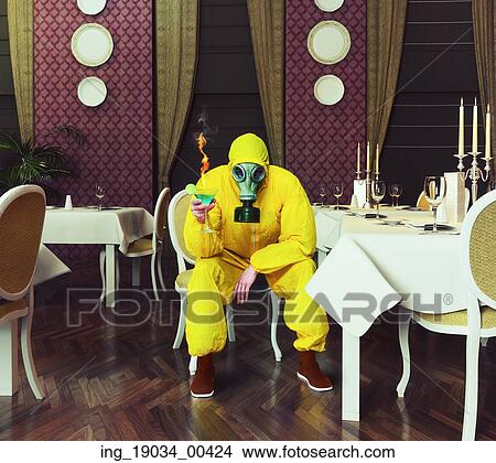 the man in a protective coverall sitting in an empty restaurant with a drink. Photo combination creative concept View Large Photo Image Picture - the man in a protective coverall sitting in an empty restaurant with a drink. Photo combination creative concept. Fotosearch
