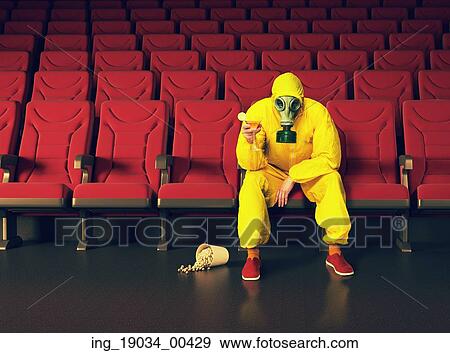 the man in a protective coverall sitting in an empty theater. Creative concept View Large Photo Image Stock Photo - the man in a protective coverall sitting in an empty theater. Creative concept. Fotosearch
