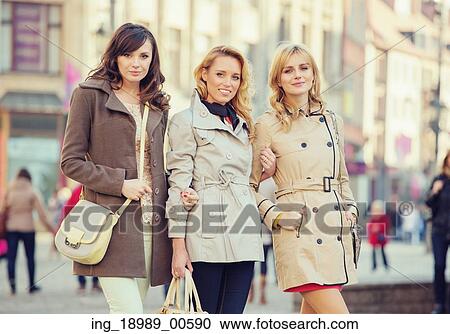 Stock Image - Three attractive women during spring day. Fotosearch